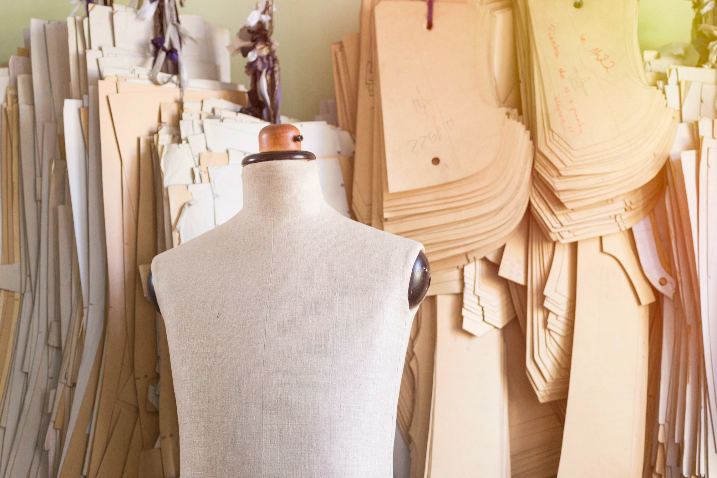 Mannequin in Bespoke Tailor Studio against Cardboard Sewing Pattern